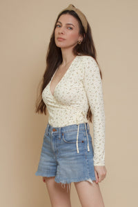 Floral print, wrap style bodysuit, in light yellow.