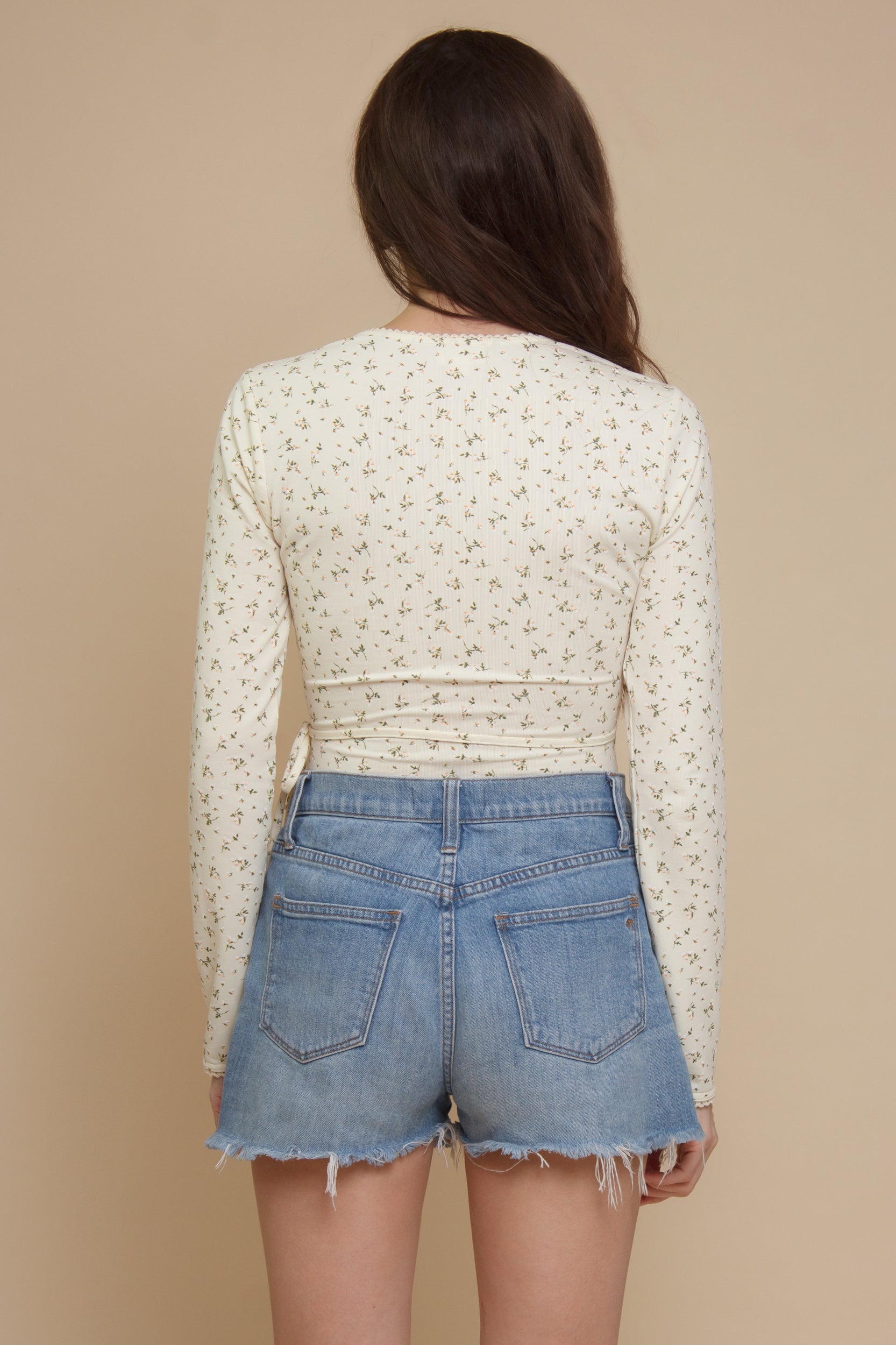 Floral print, wrap style bodysuit, in light yellow.