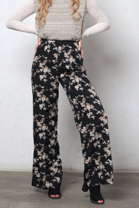 Wide leg, floral print pants, in black. Image 3