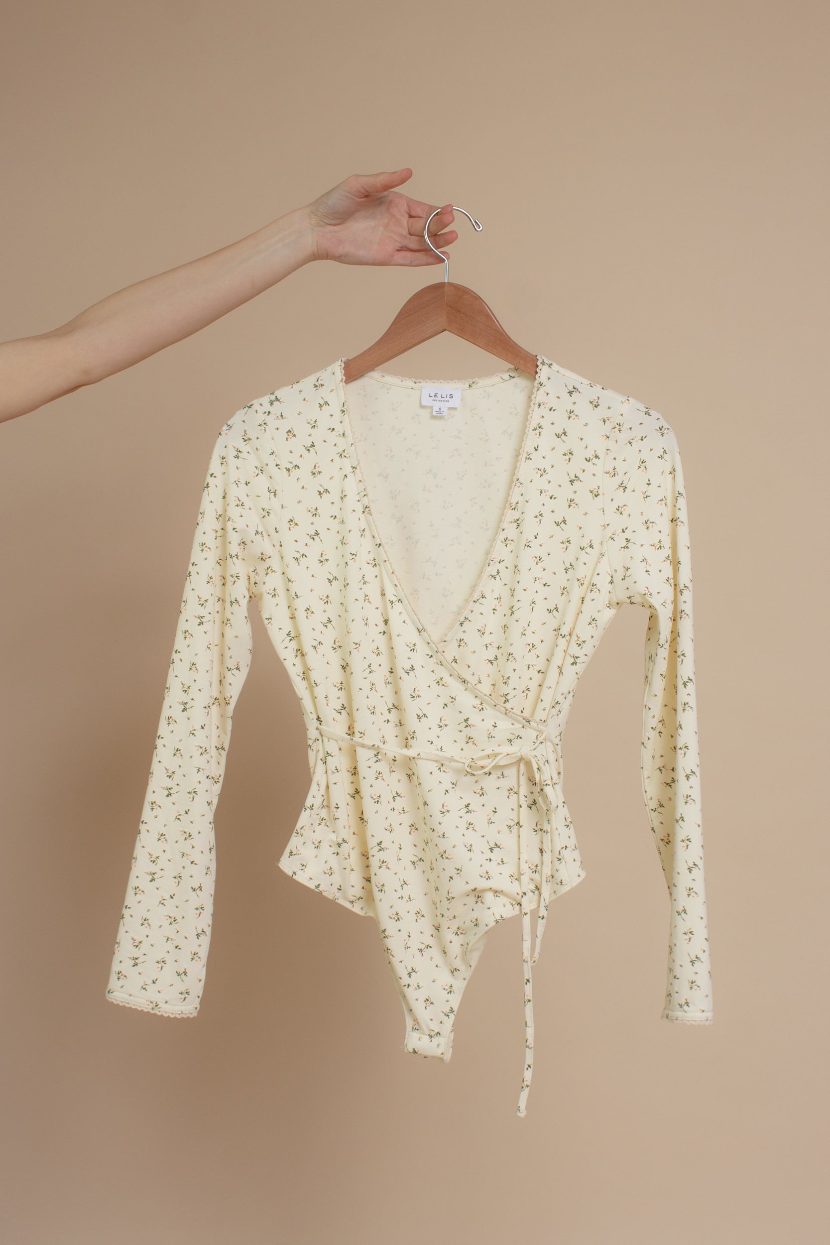 Floral print, wrap style bodysuit, in light yellow.