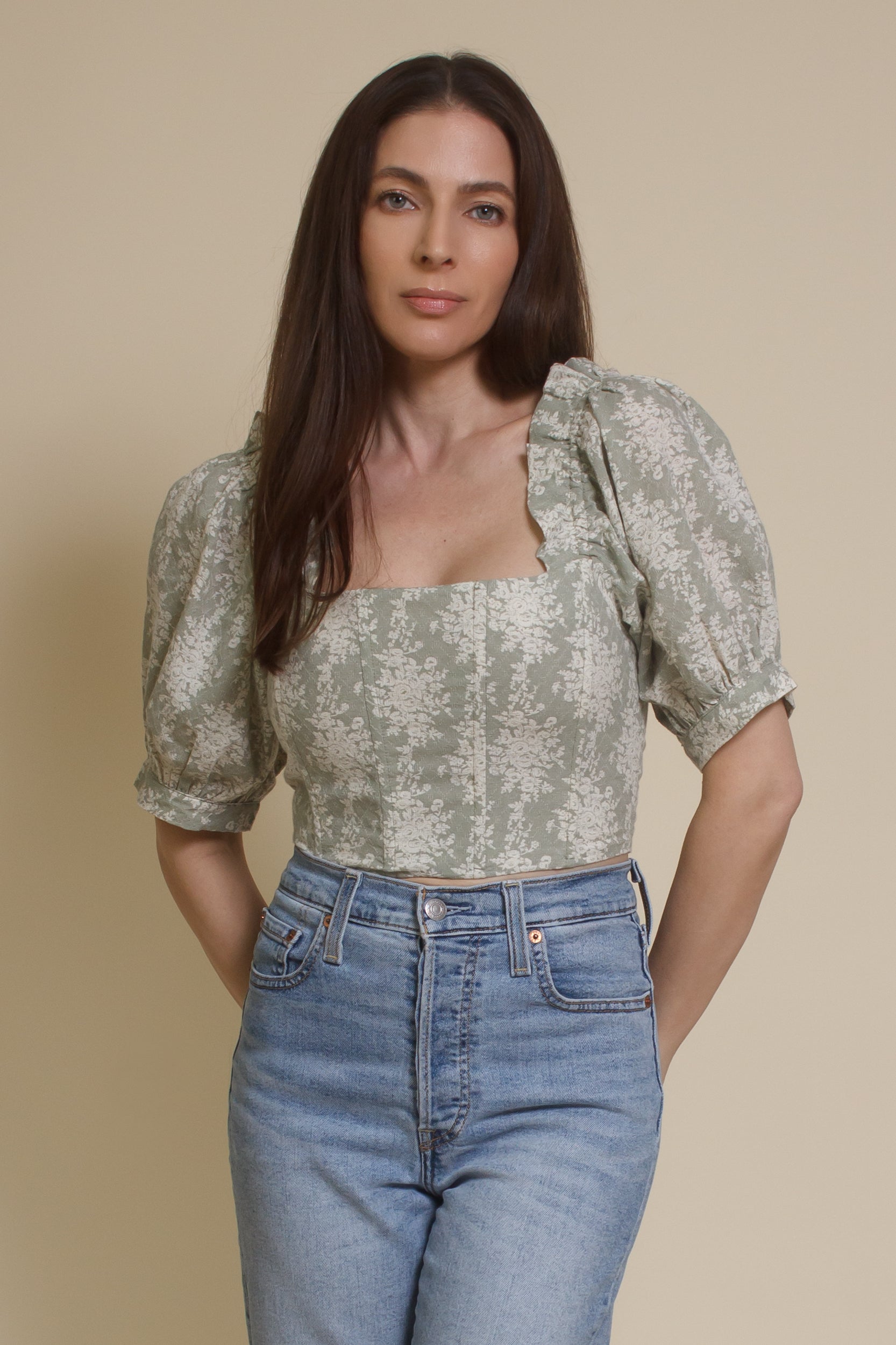 Olivaceous floral jacquard corset top with puff sleeves, in sage cream. (Front)