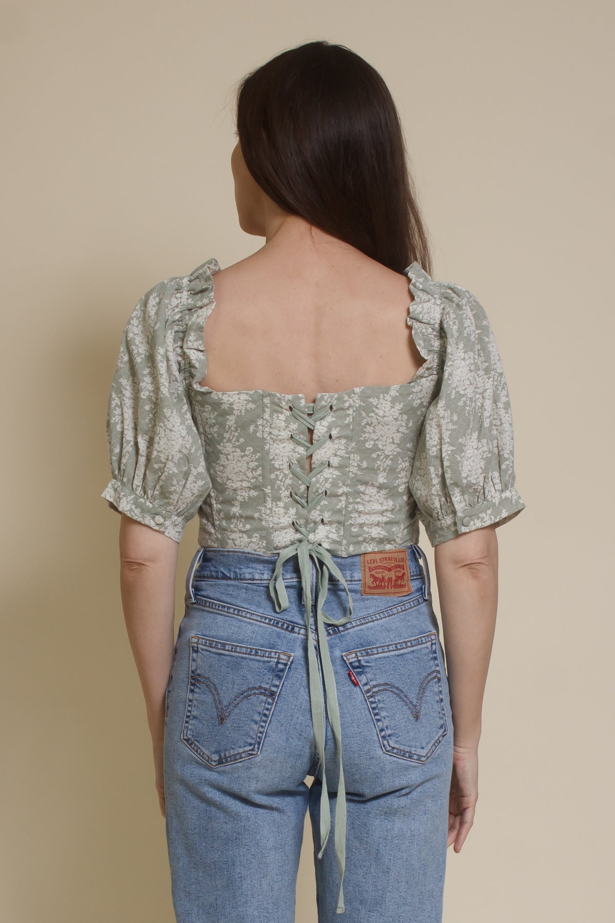 Olivaceous floral jacquard corset top with puff sleeves, in sage cream. (Back)