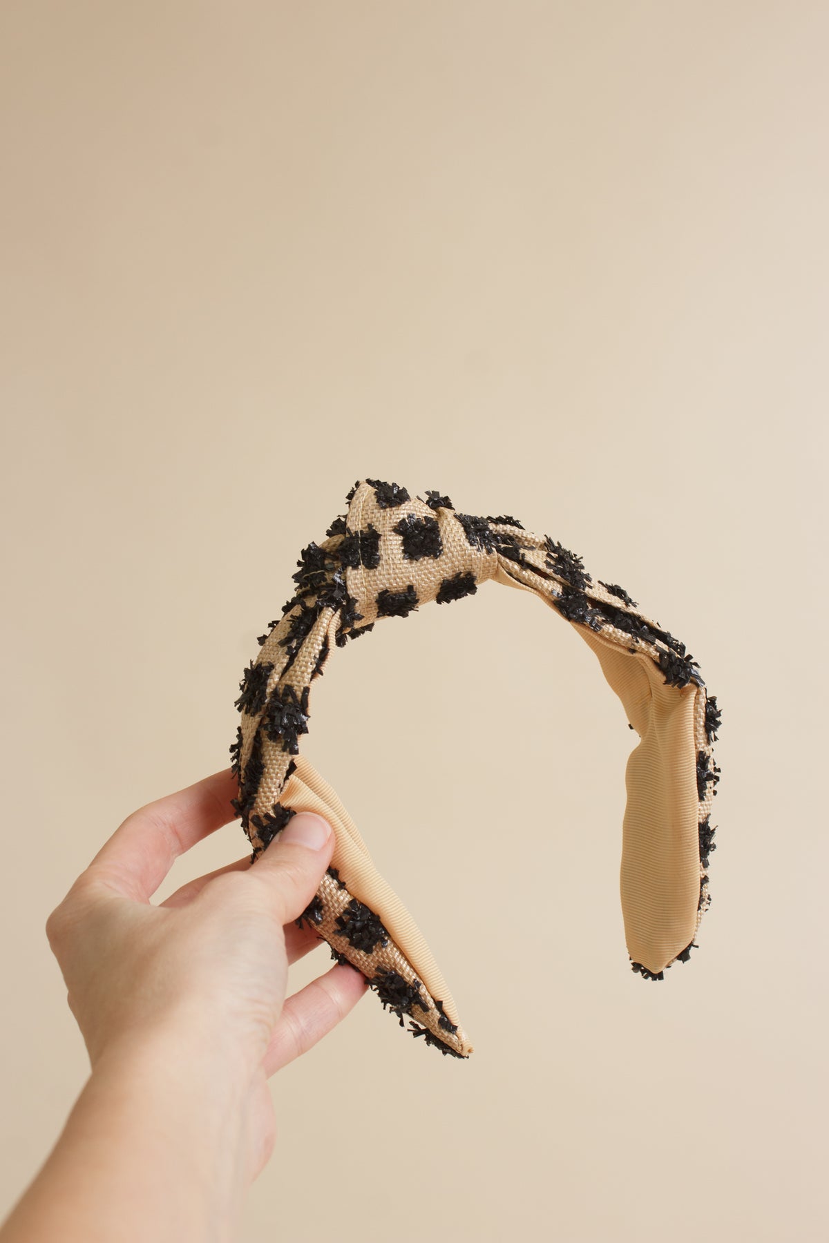 Franklin Sunset woven headband with black textured dots.