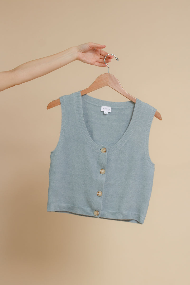 Button front sweater vest, in blue.