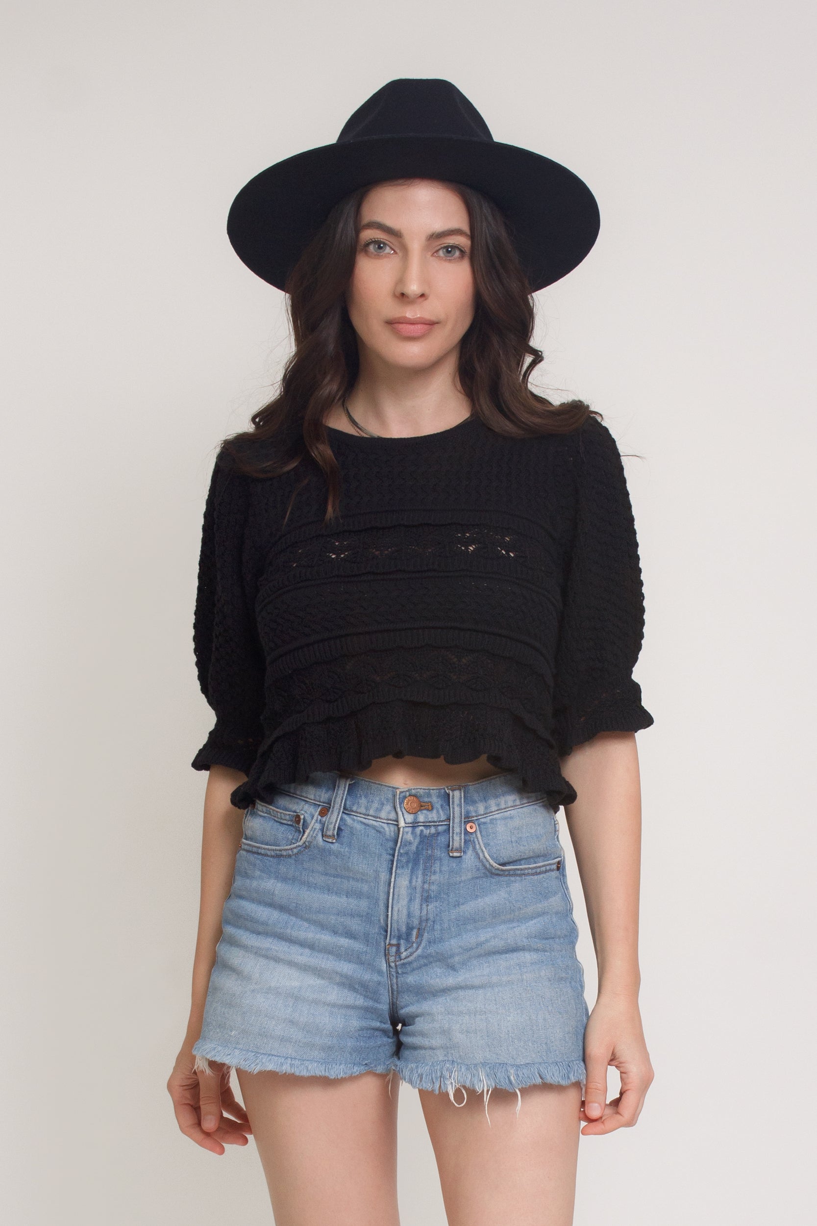Jacquard sweater top with puff sleeves, in black.